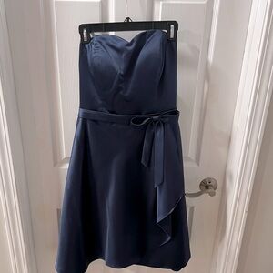 Navy blue satin strapless dress with sweetheart neckline and bow detail